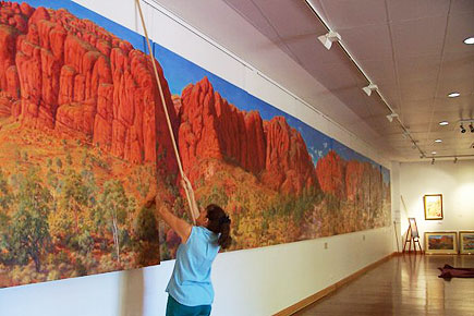 Nadeen hanging the giant painting